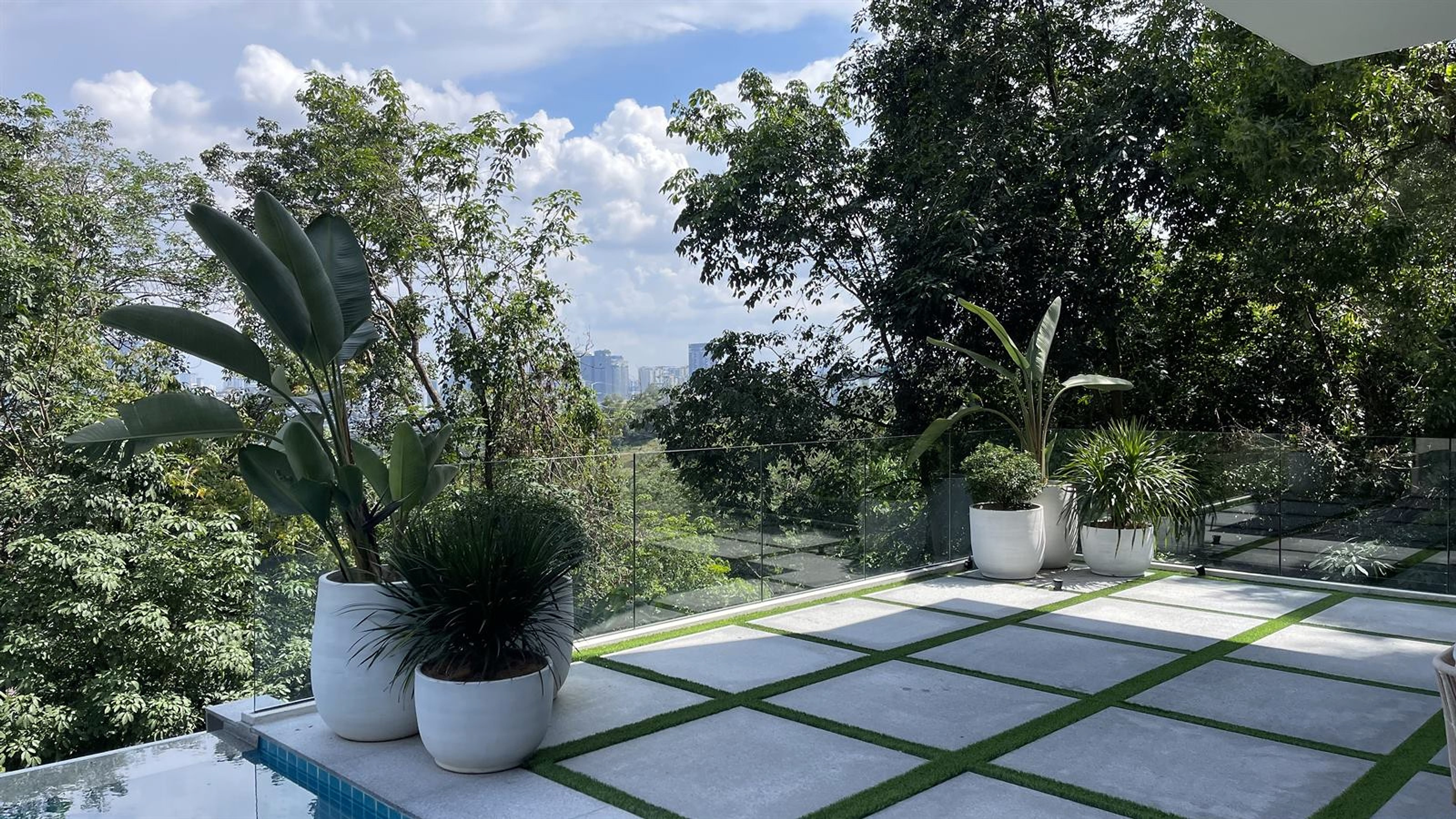 Premium tropical home landscape with lush greenery by RimbaScape Solutions